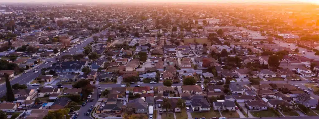 Aerial view of Downey, California residential neighborhoods during sunset, illustrating Haven House Sober Living’s virtual support for local residents.